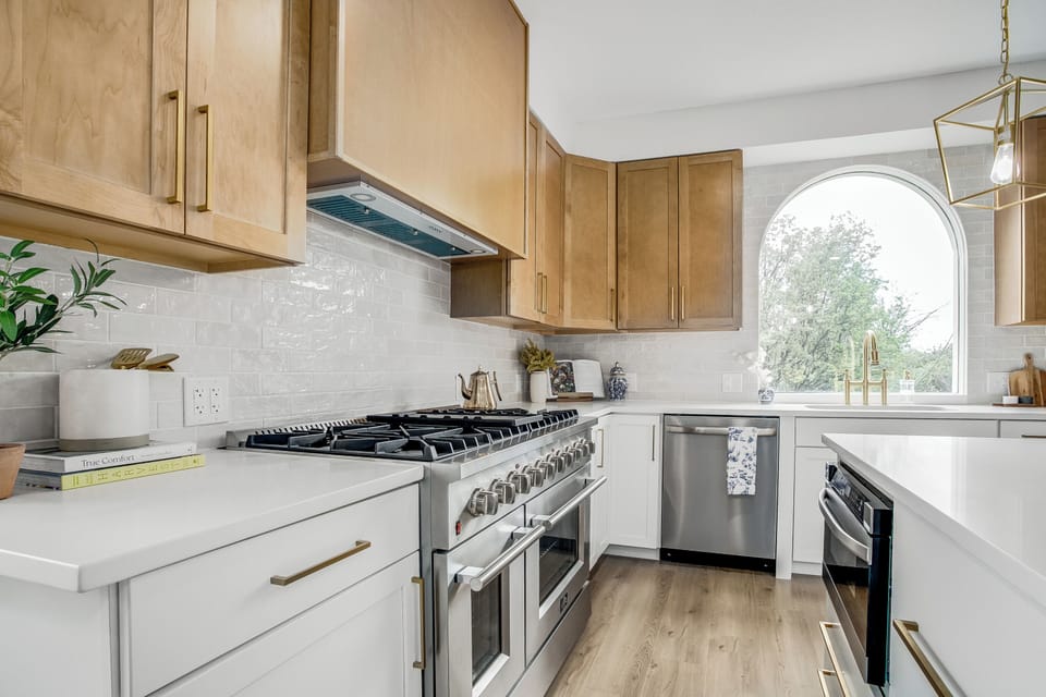 Fully equipped kitchen with premium appliances and natural light.