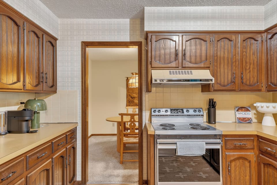 Charming kitchen entry with warm wood cabinetry and inviting character.