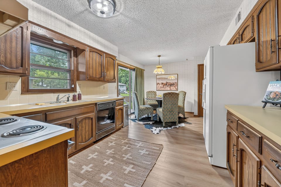 Functional galley kitchen with generous storage and modern appliances.