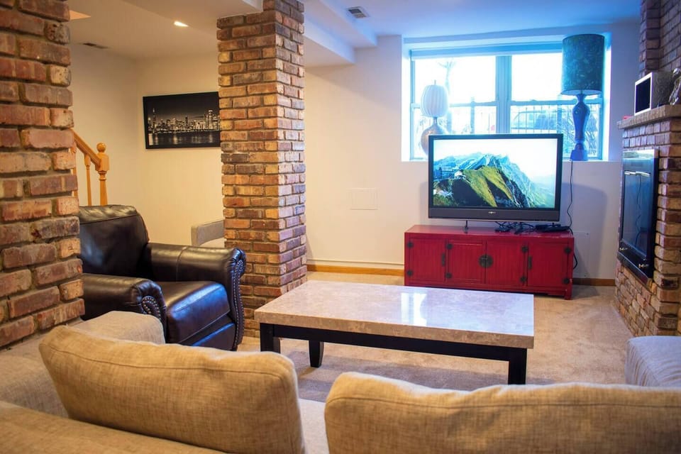 Cozy lower-level living room with TV and lounge seating