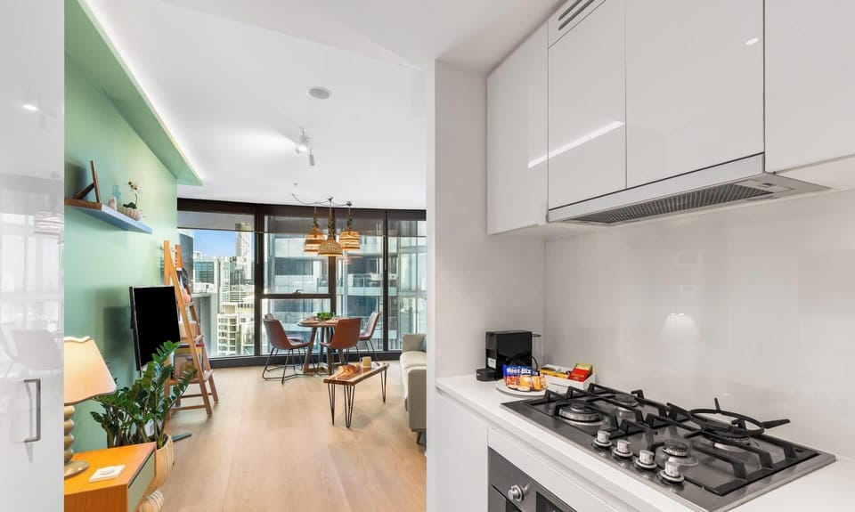 Nicely laid out galley style kitchen featuring four burner gas cooktop in foreground