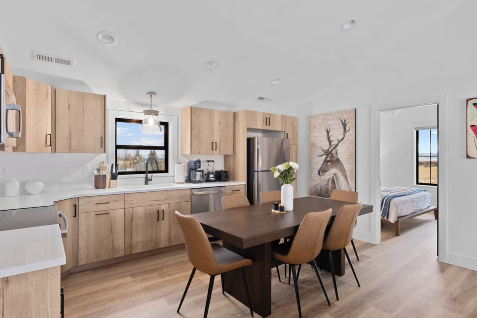 Bright kitchen-dining with coffee bar, stainless appliances & country views.