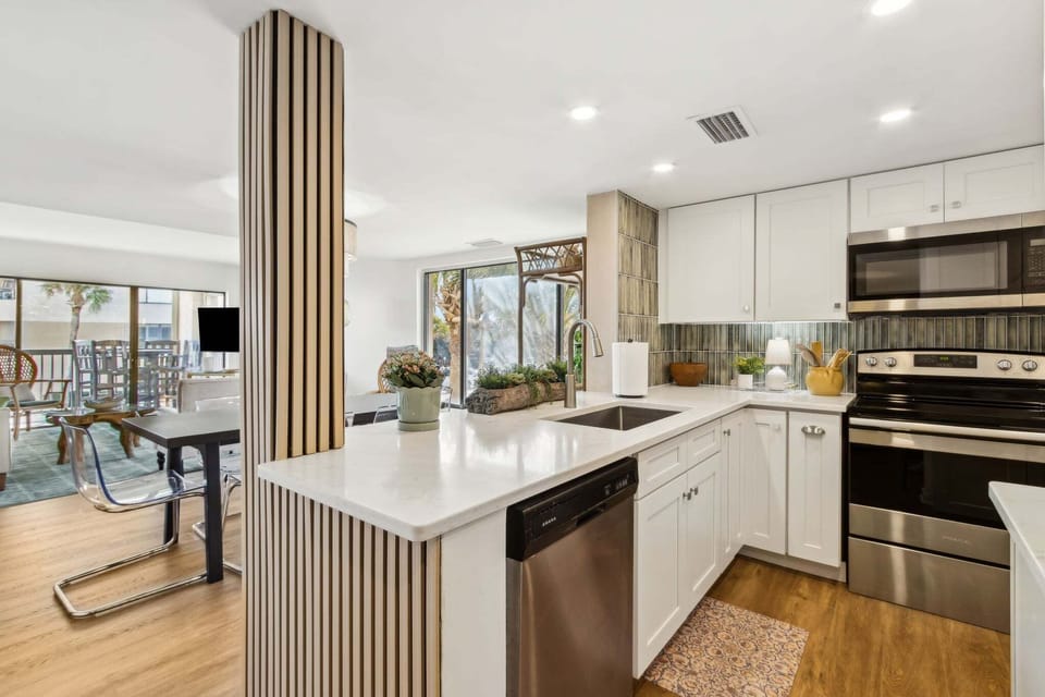 Newly Updated Kitchen with Quartz Countertops, Stainless Steel Appliances, and Stylish Tiled Backsplash
