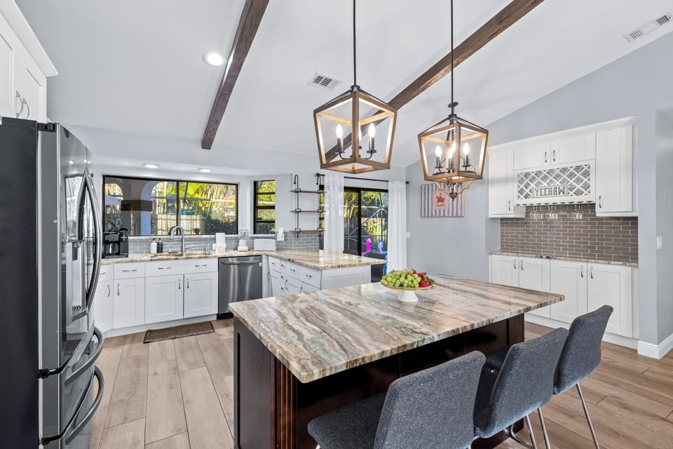 Cook, gather, and entertain with ease in this spacious chef’s kitchen featuring dual islands and poolside views.