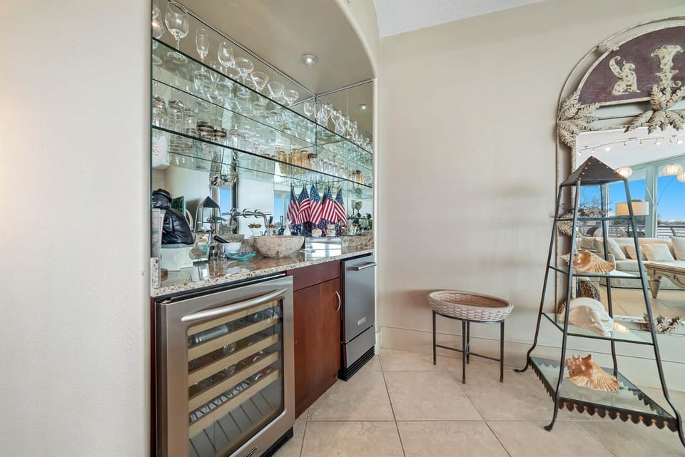 Perfect for entertaining, this dining area features a convenient wet bar with a wine cooler and blender. Create memorable gatherings in this stylish and functional space.