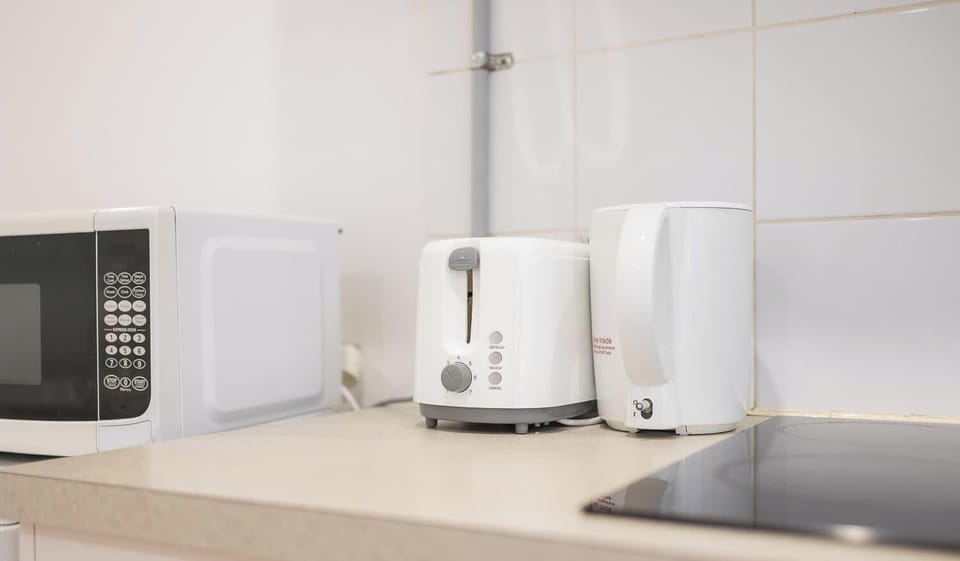 
Convenient countertop area with toaster and kettle, ideal for breakfast and light meals.