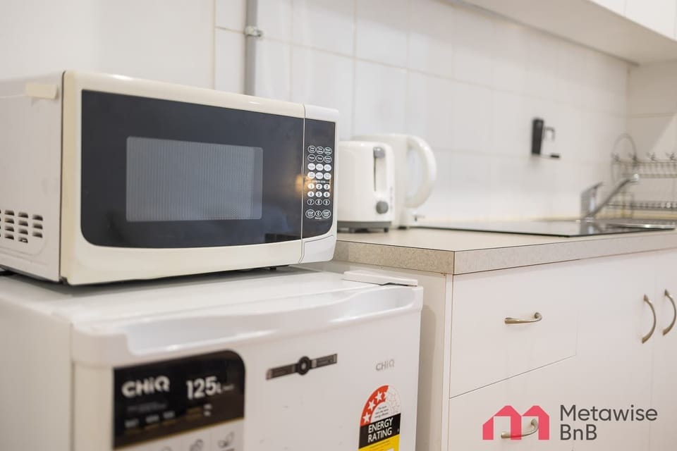 
Microwave and kettle setup for quick and easy meal preparation.