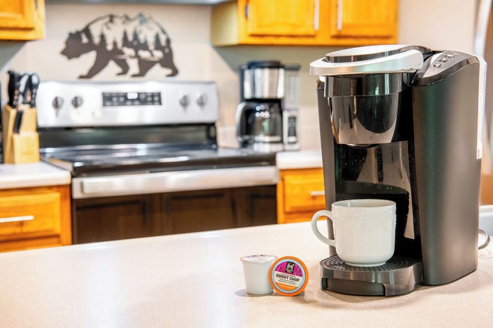 Start your mornings right with a fresh cup of coffee from your fully equipped kitchen, complete with modern appliances and a charming mountain-inspired touch.