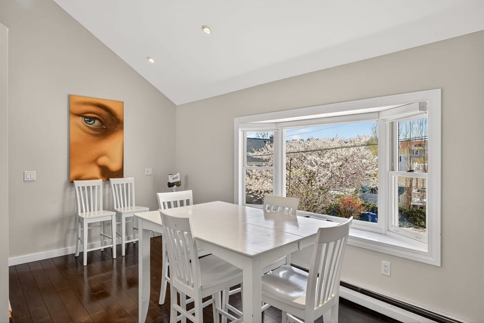 Your dining area frames stunning springtime cherry blossoms through expansive windows, creating a bright and inspiring space for memorable meals together.