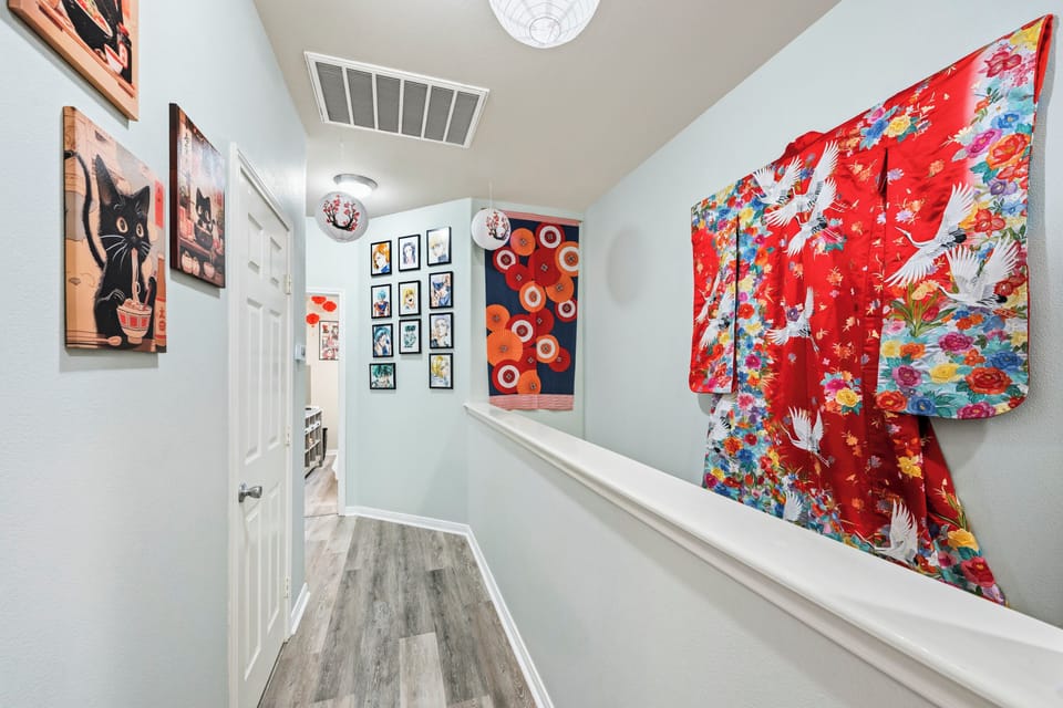 A bright hallway adorned with a Japanese wedding robe and Anime artwork handcrafted by owner.  The eclectic mix of colors and textures adds personality to your stay.
