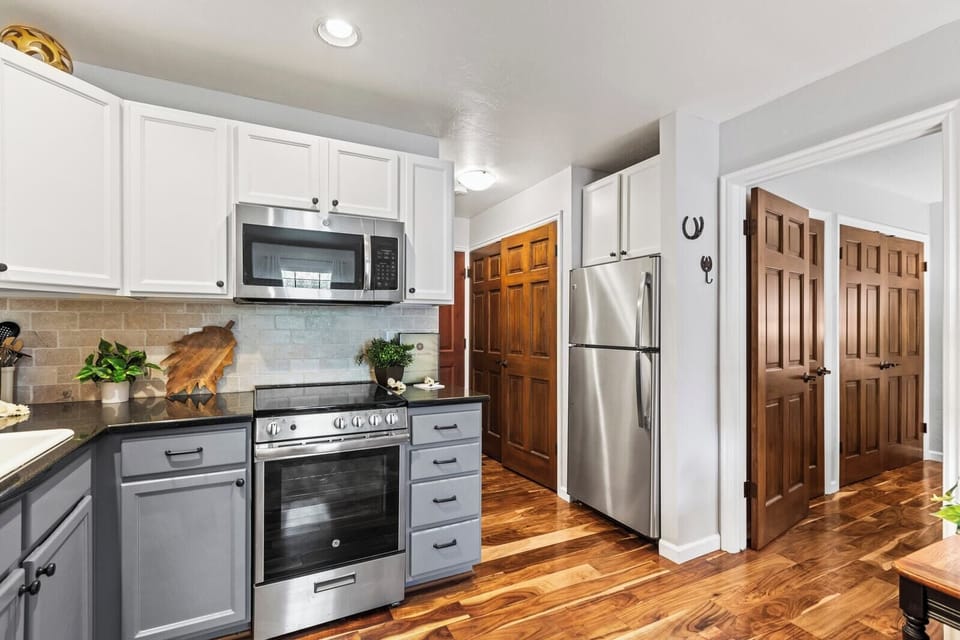 Granite countertops and stainless appliances bring modern convenience to this compact kitchen.
