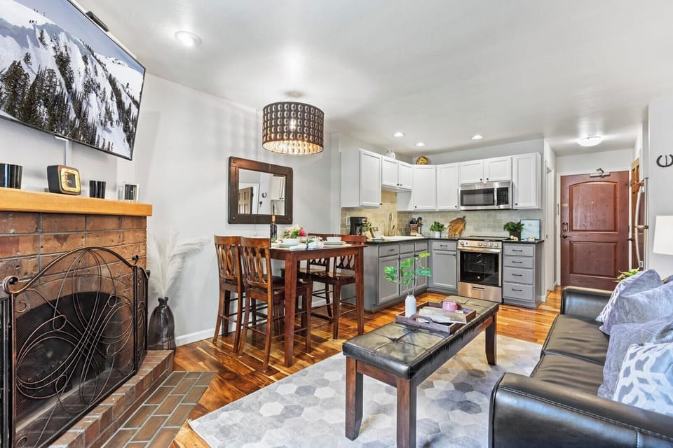 Warm wood tones and a fireplace create a welcoming setting for shared meals or game nights.