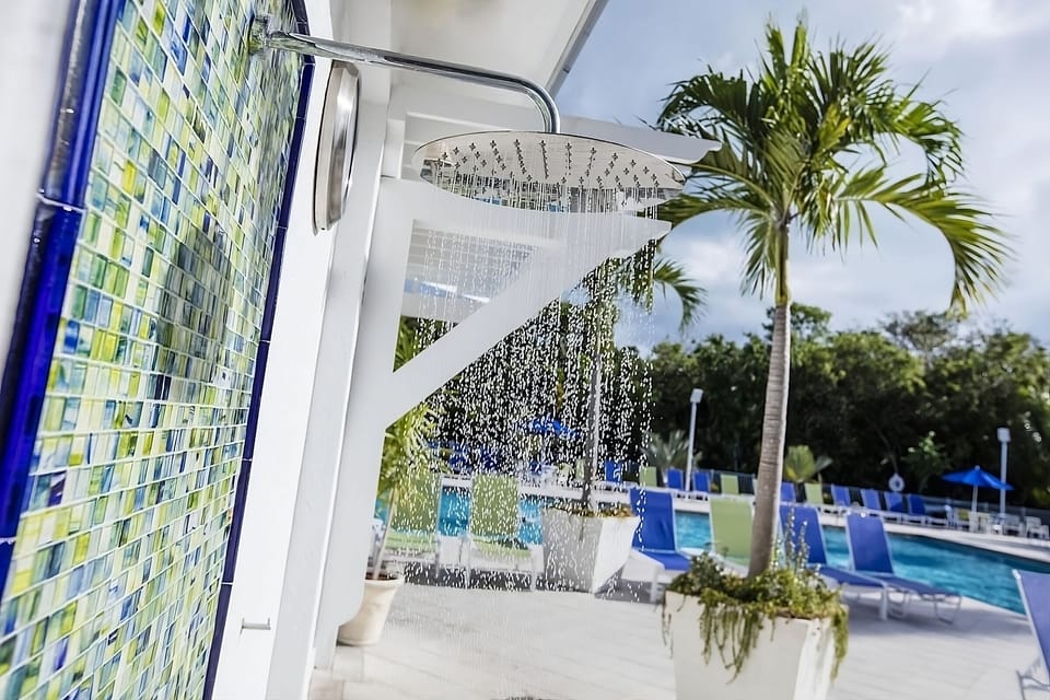 Cool off poolside with palms, loungers, and sunny vibes.
