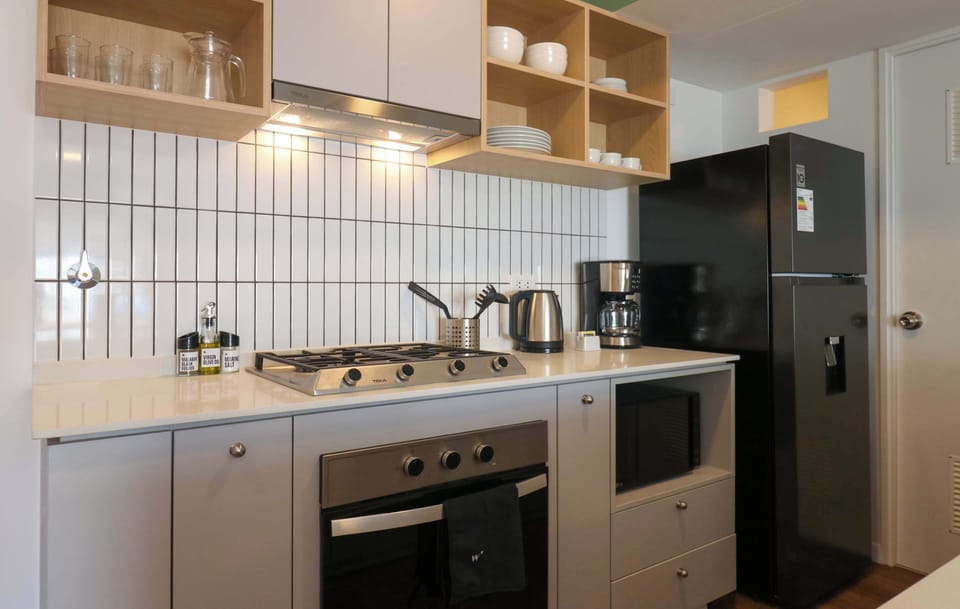 Stylish modern kitchen with built-in appliances and wooden accents