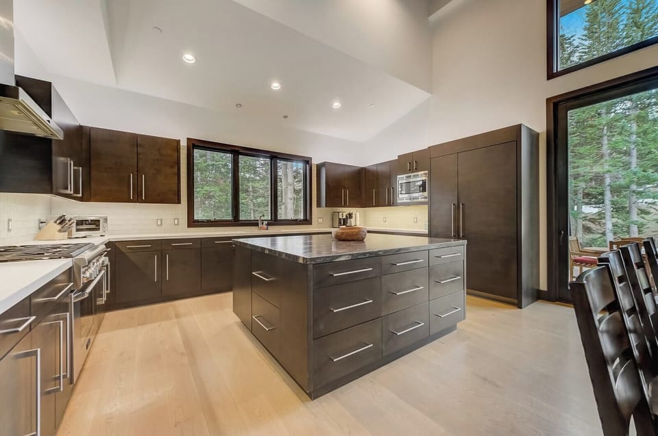 Sleek design meets function in your chef’s kitchen with island seating and open layout.