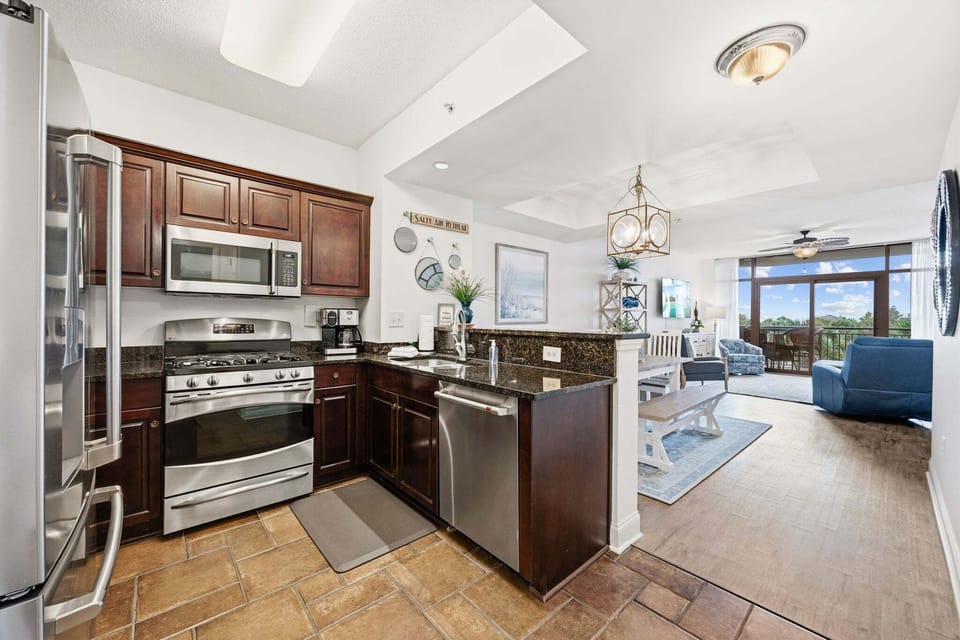 The open concept Kitchen offers granite countertops and stainless appliances, including a gas range and breakfast bar.