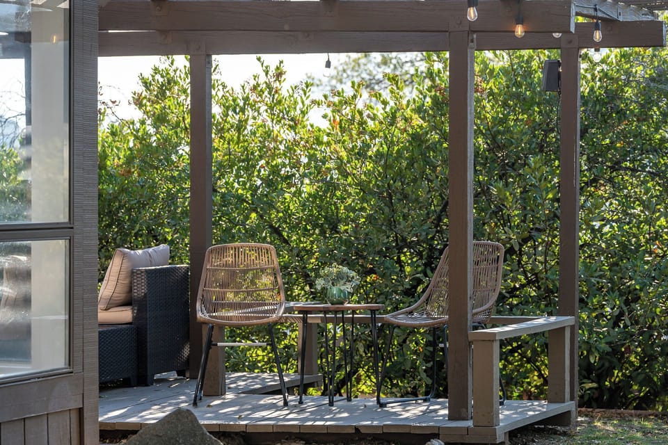 Sip your morning coffee or unwind in the evening on this peaceful porch swing surrounded by trees.