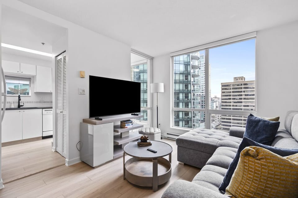 Living Room: Urban retreat with stunning views, plush seating, and vibrant decor await your arrival!