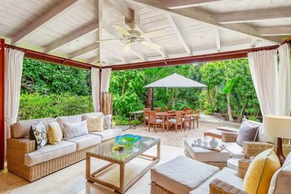 Peaceful verandah area with comfortable seating and views out to the private garden.