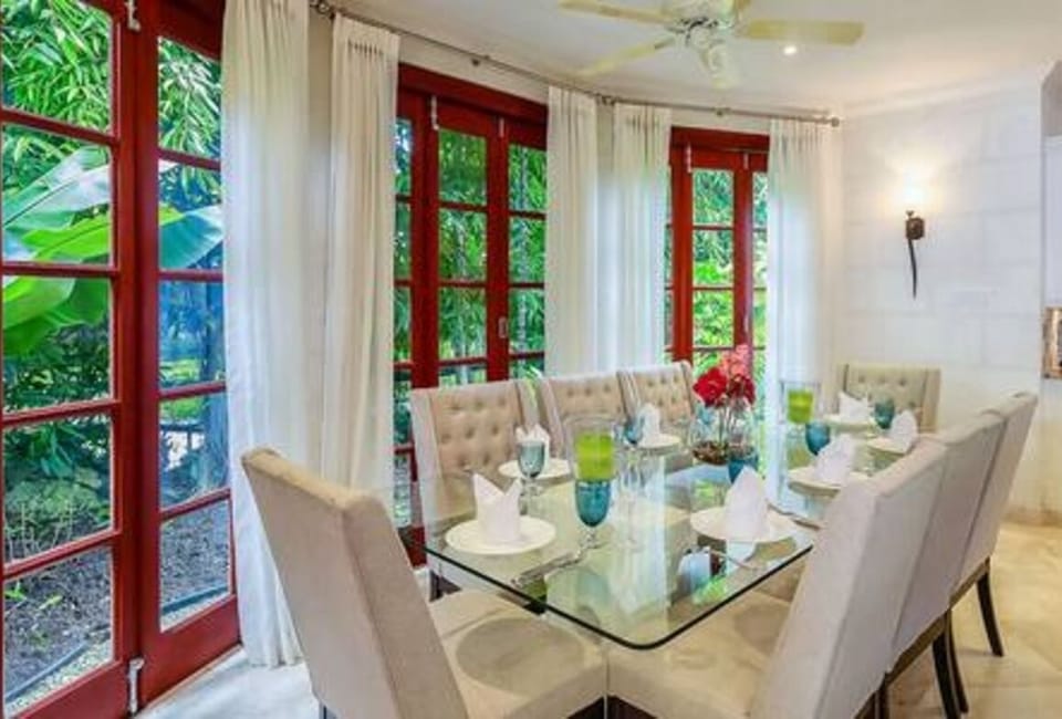 Sleek dining space for 8 guests set within the open plan living space, with views over the garden.