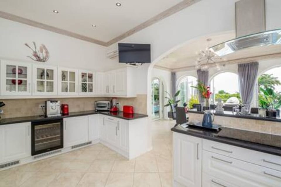 Fully equipped kitchen with breakfast bar, blender, juicer, dishwasher, kettle, microwave, oven, toaster.  Also available is a washing machine and tumble dryer.