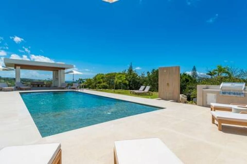Stunning views from the pool and modern gazebo seating area, looking out over the horizon.