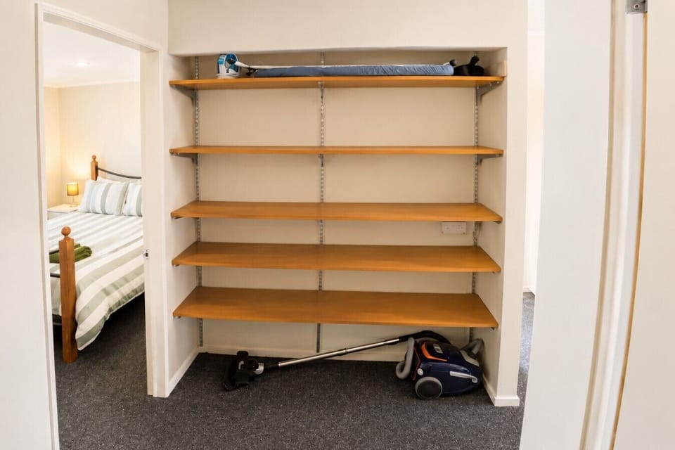 Convenient storage facilities including vacuum cleaner and ironing board for longer stays