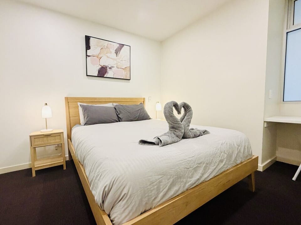 Comfortable queen bedroom with fresh linen, ideal for couples, solo travellers or business stays.