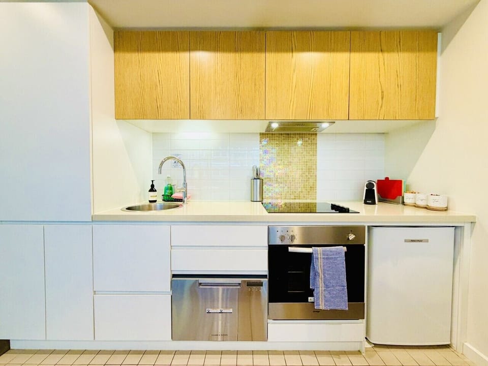 Fully equipped kitchen with cooktop, oven, dishwasher and essentials for longer stays.