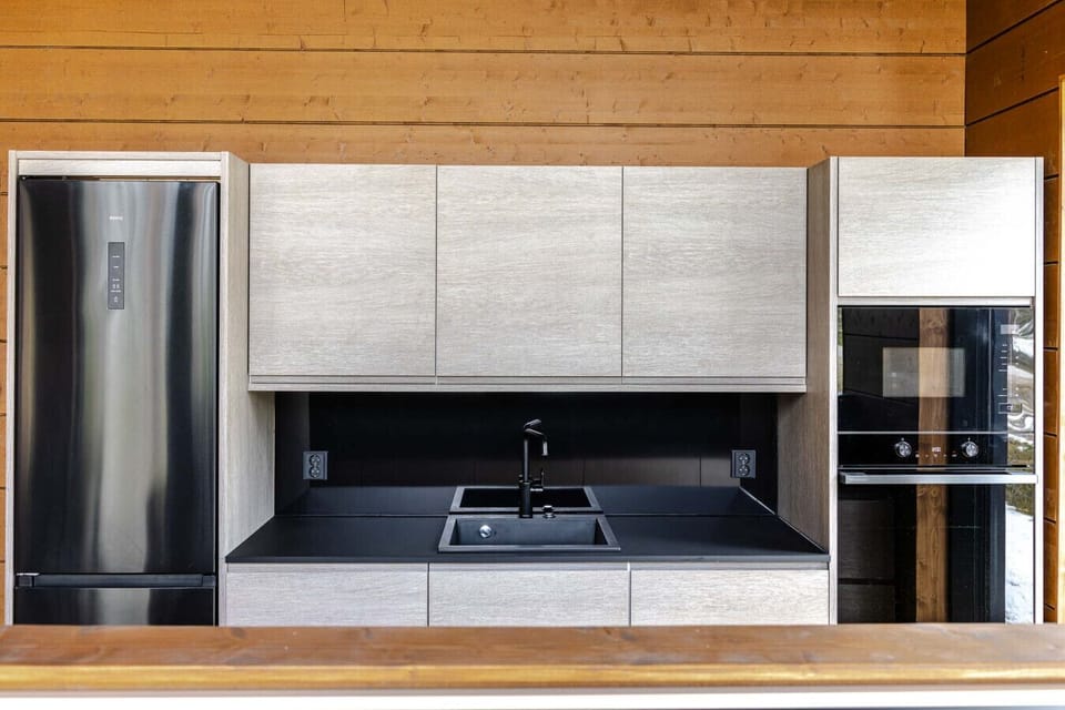 Prepare gourmet meals with ease using our suite of high-end integrated appliances, including a full-sized refrigerator and modern oven. The minimalist workspace is designed for both functionality and style, ensuring a clutter-free environment.