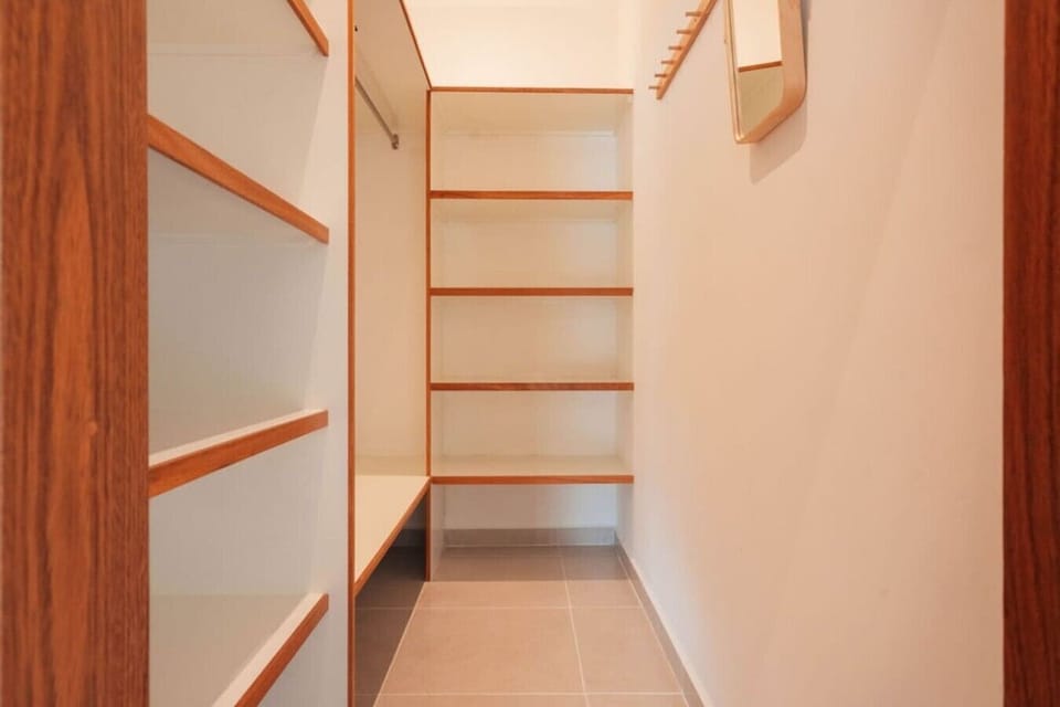 Walk-in closet with plenty of shelving and storage space.