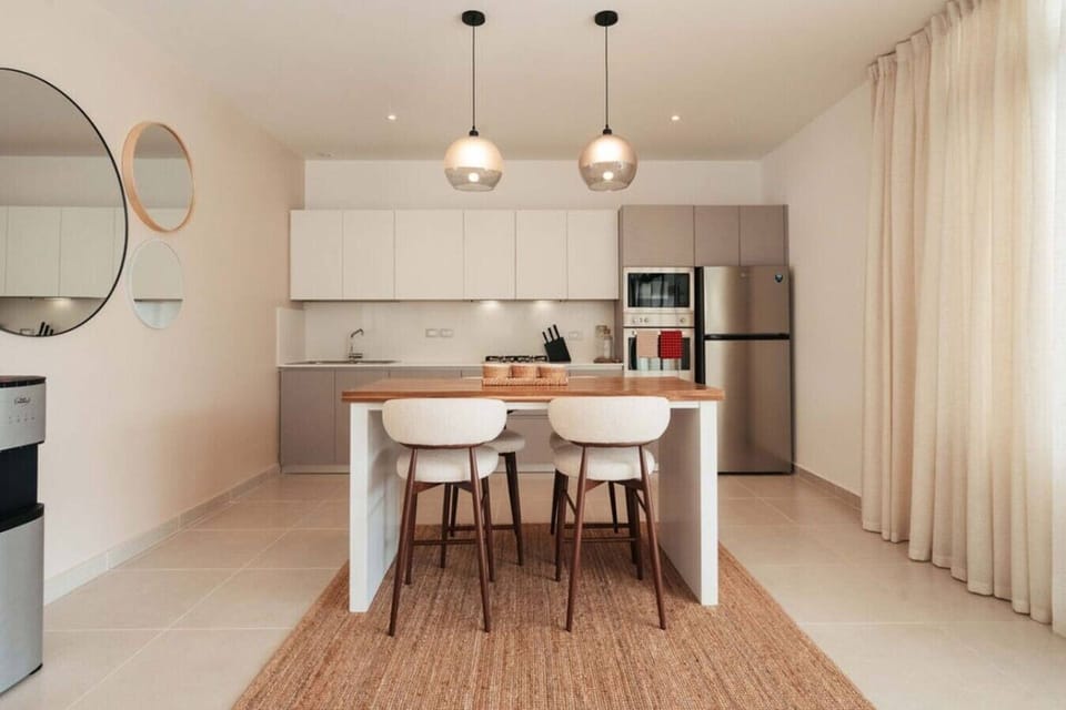 Fully equipped kitchen with a breakfast bar, modern appliances, and plenty of counter space.