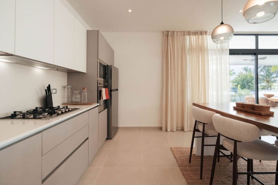 Spacious kitchen with plenty of counter space, modern appliances, and a dining area nearby.