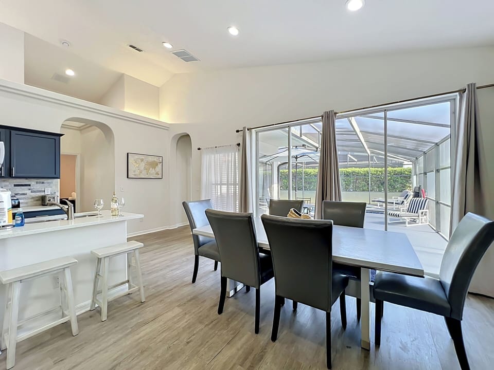 Bright dining area with easy access to the pool patio for indoor-outdoor living.