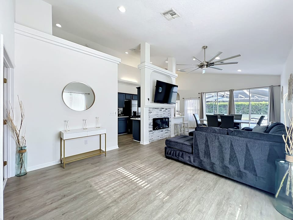 Open-concept living room with cozy seating, Smart TV, and relaxing natural light.