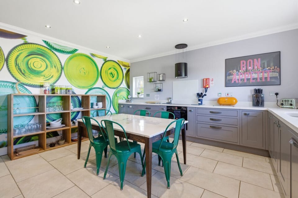 Bold plates feature wall and Tube-map table in the family kitchen.
