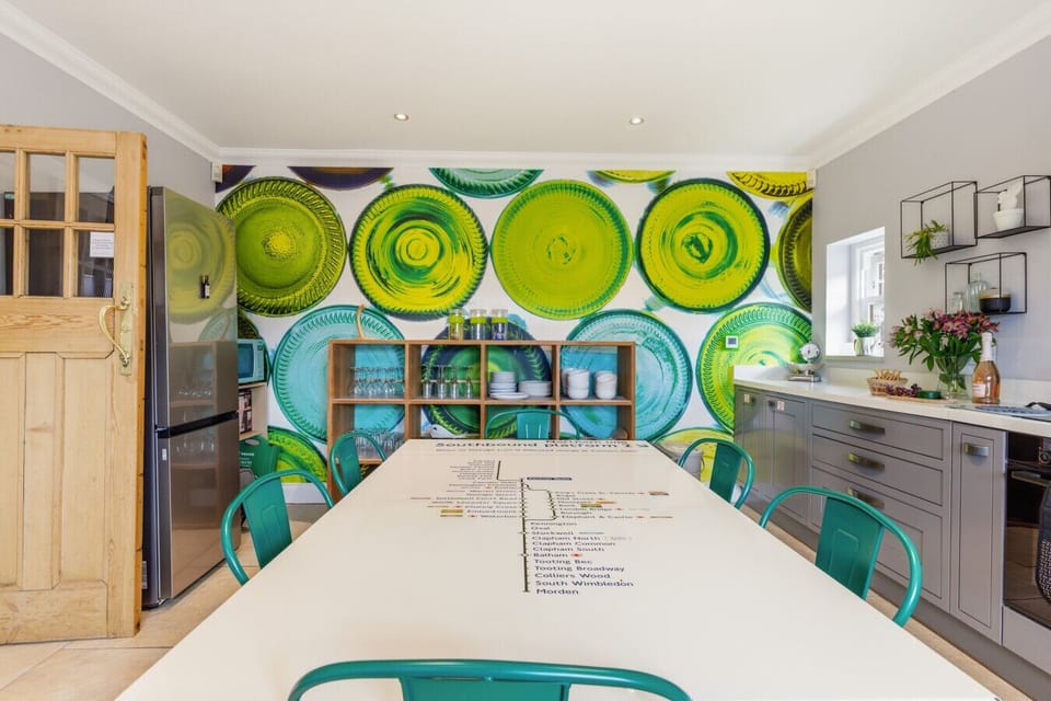 Family kitchen with shaker cabinets and London Tube-map dining table.