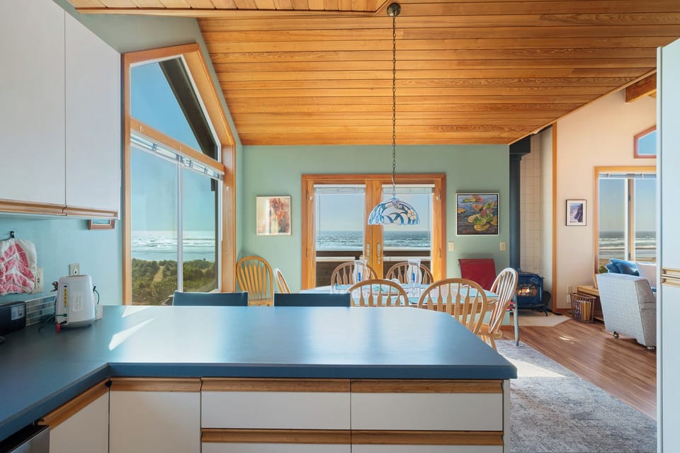 Gather around the dining table, where stunning ocean views frame every meal through floor-to-ceiling windows, and the open-concept design invites effortless relaxation and connection.