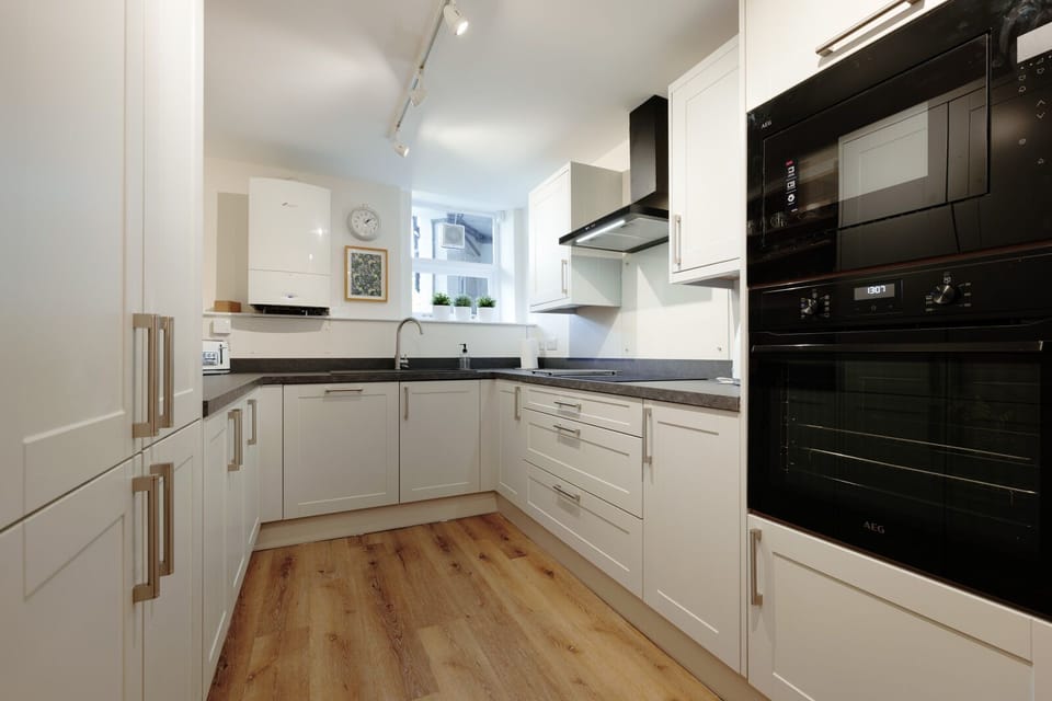 A fully equipped kitchen with comfortable seating