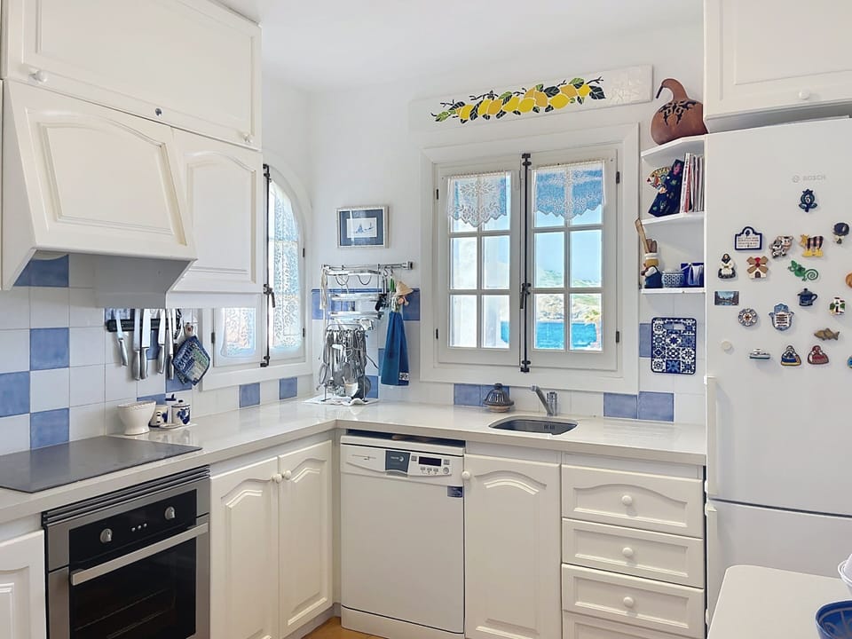 Modern kitchen fully equipped with dishwasher, oven, hob, large fridge and freezer, with sea views.
