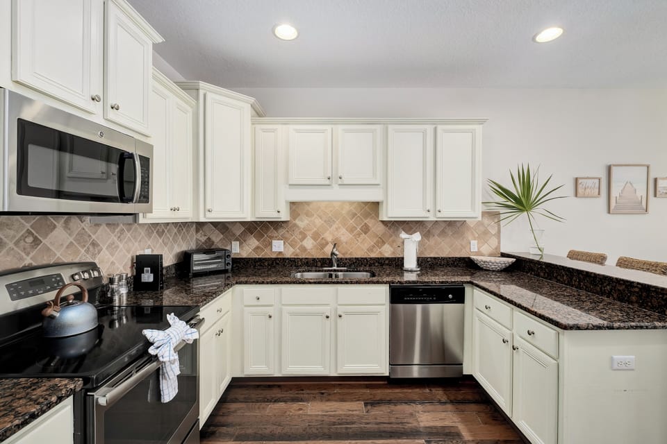 Picture yourself preparing meals in this bright, fully-equipped kitchen with gleaming granite counters, modern appliances, and plenty of cabinet space for all your vacation essentials.