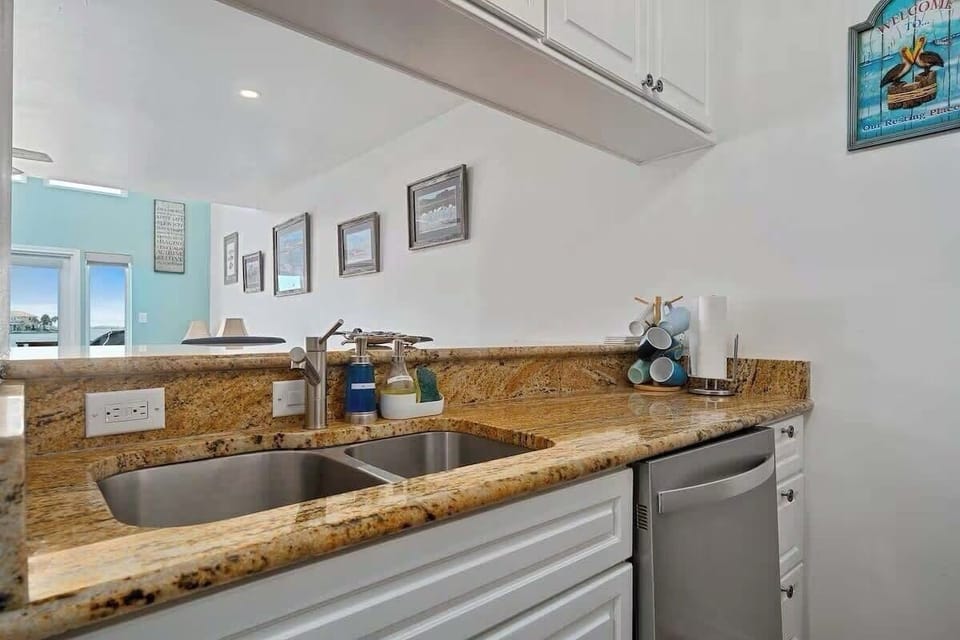 Kitchen with bar opening into living/dining room 