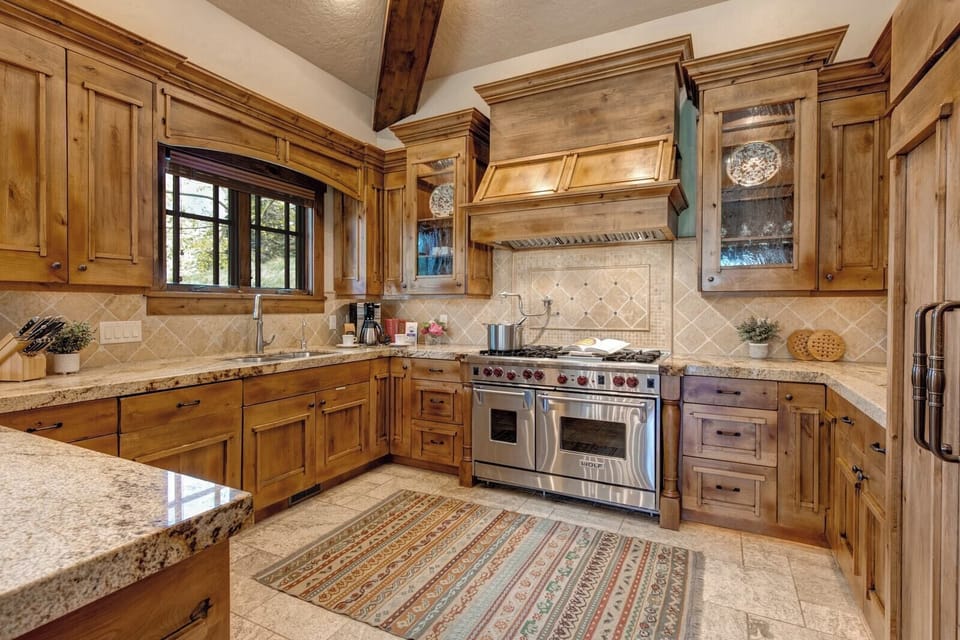 A full view of your kitchen’s custom millwork, professional-grade appliances, and granite counters.