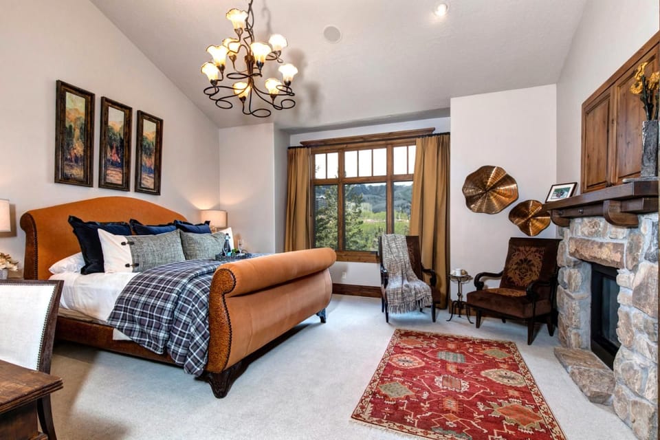 This main-level suite features a King bed, fireplace and sitting area