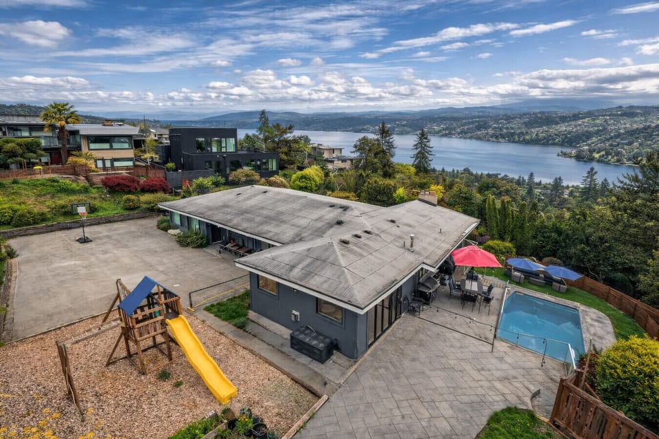 Premier outdoor living with a view. This expansive backyard features a private swimming pool, playground, and basketball court, offering the ultimate summer retreat for your group.