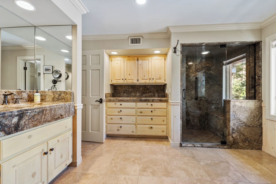 Bathroom with walk-in shower and window