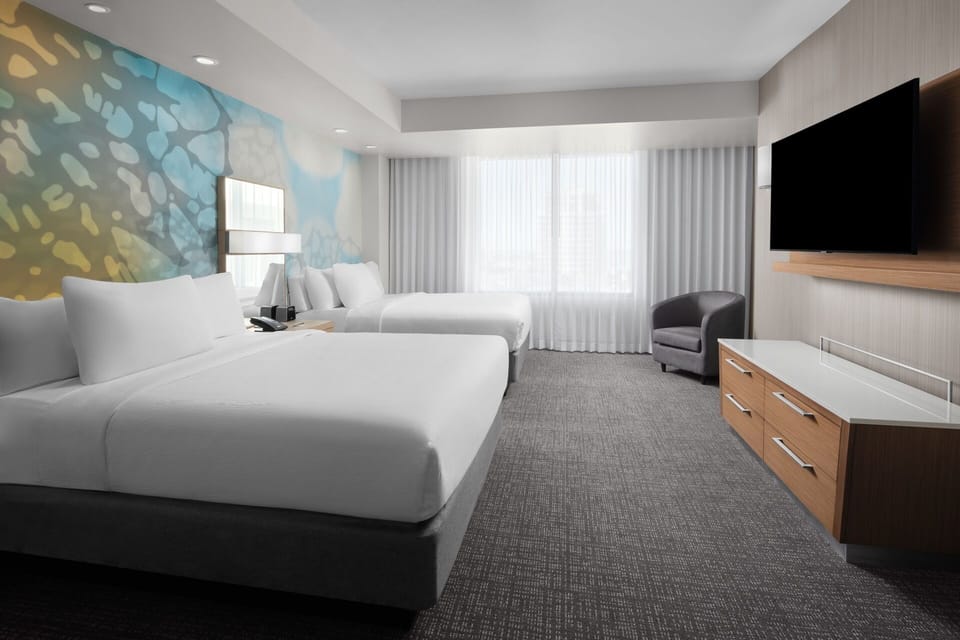 Wake up refreshed in a serene room with comfy lounge chair