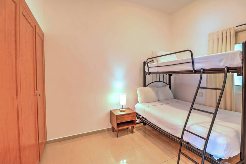 Second bedroom with a double bed and a single bed with a closet.