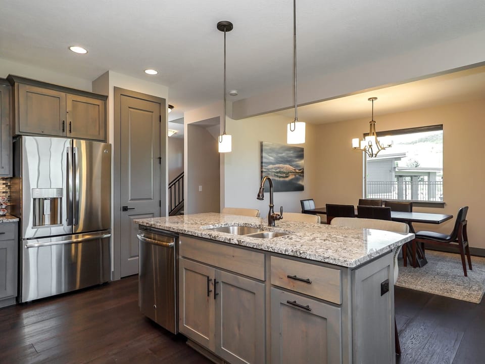 Fully equipped kitchen with stainless steel appliances and ample space.
