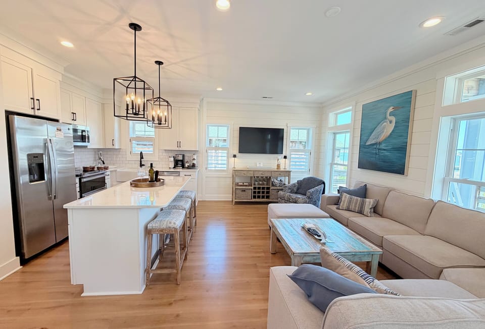 The living area features a bar, large screen TV & comfortable seating.